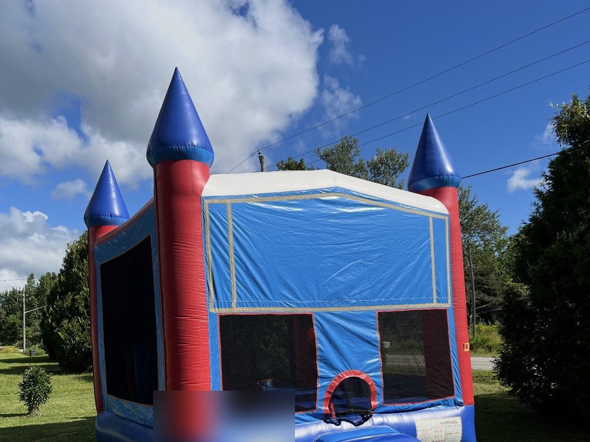The Ultimate Playzone bounce house, red and blue